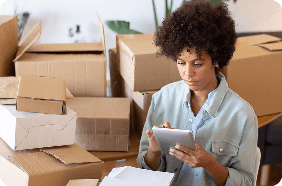 A cobbler stays organized while handling orders and designs on their tablet, ensuring their business runs smoothly.