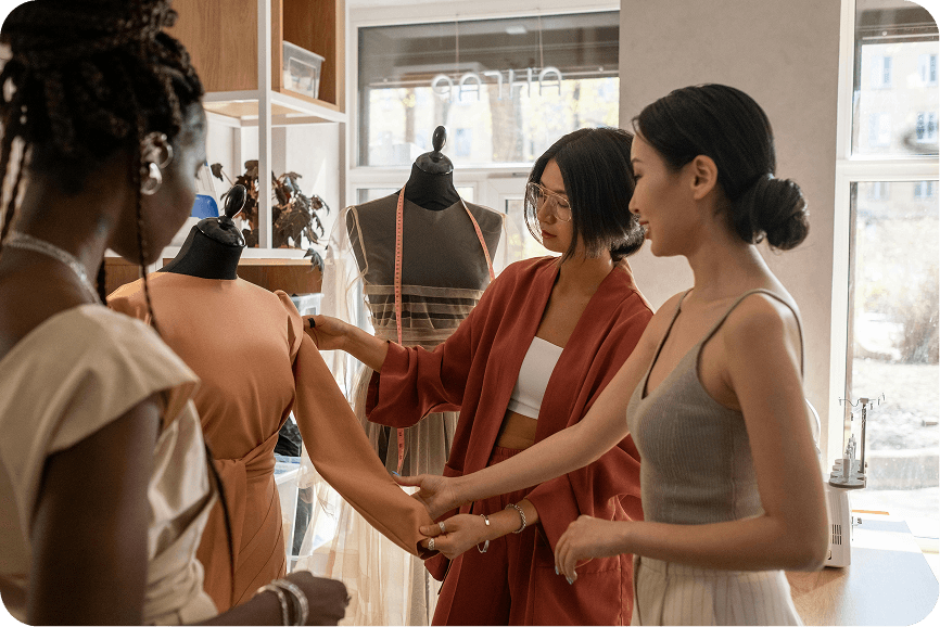 Fashion Designer Working on Website for Growth A fashion designer works on their laptop, building a professional website to expand and grow their fashion business online.