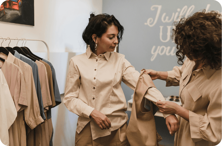 Fashion Designer Reviewing Financial and Business Analytics A fashion designer checks their key business and financial metrics reported in their Silver Spoon dashboard, evaluating the fashion business’s growth and finances.
